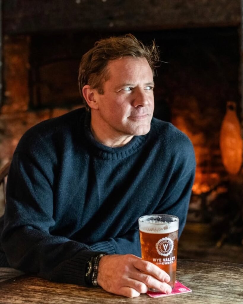 Matt Tebbutt cooking in Saturday Kitchen studio wearing chef whites and apron
